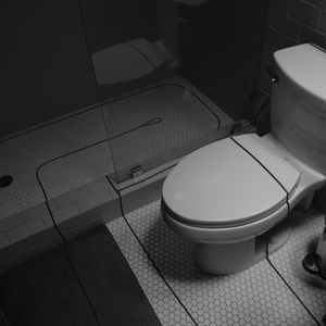 photograph of the bathroom in the artist's apartment, covered in lines of blue tape used to form the labyrinth